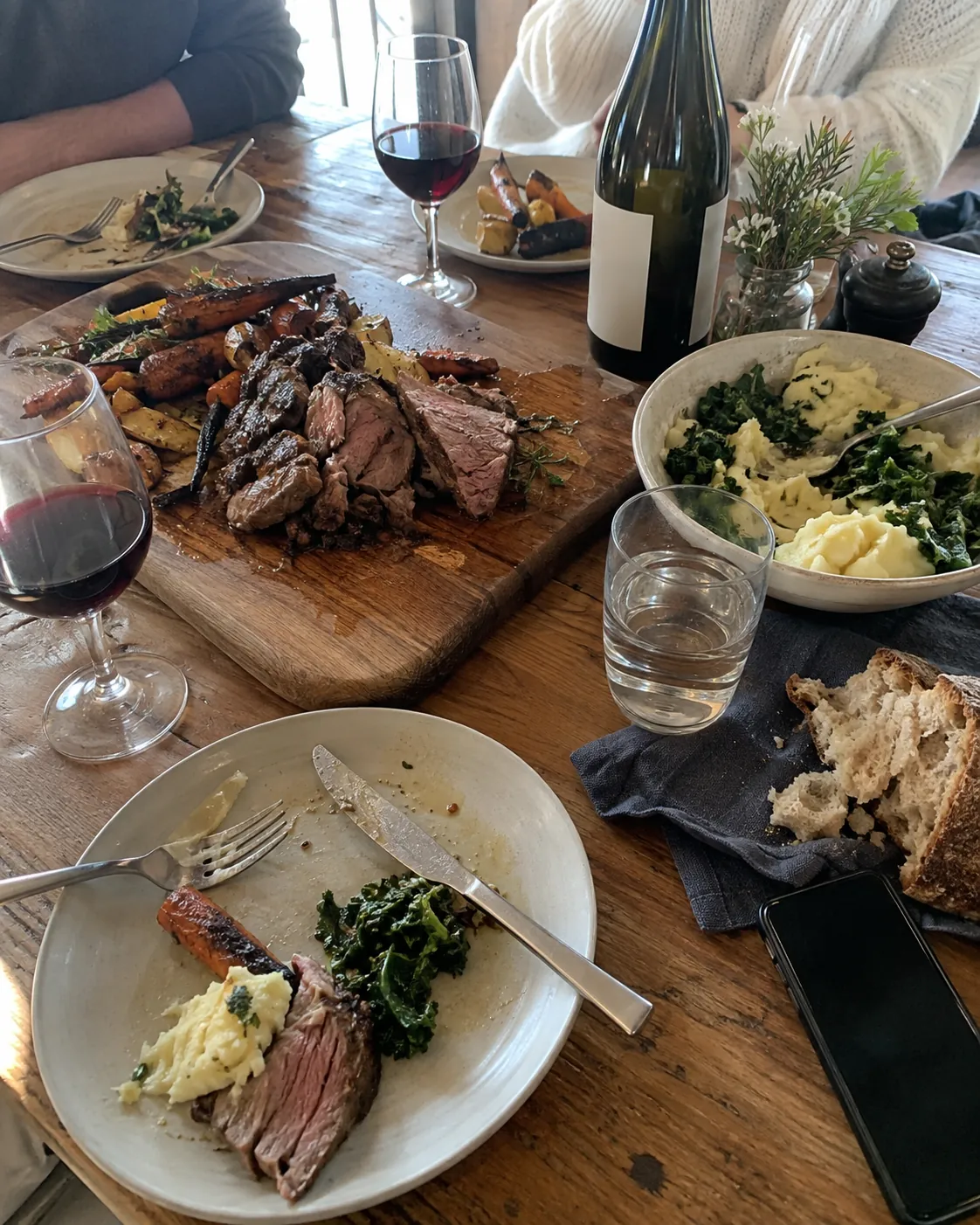 A plated lunch beside wine glasses